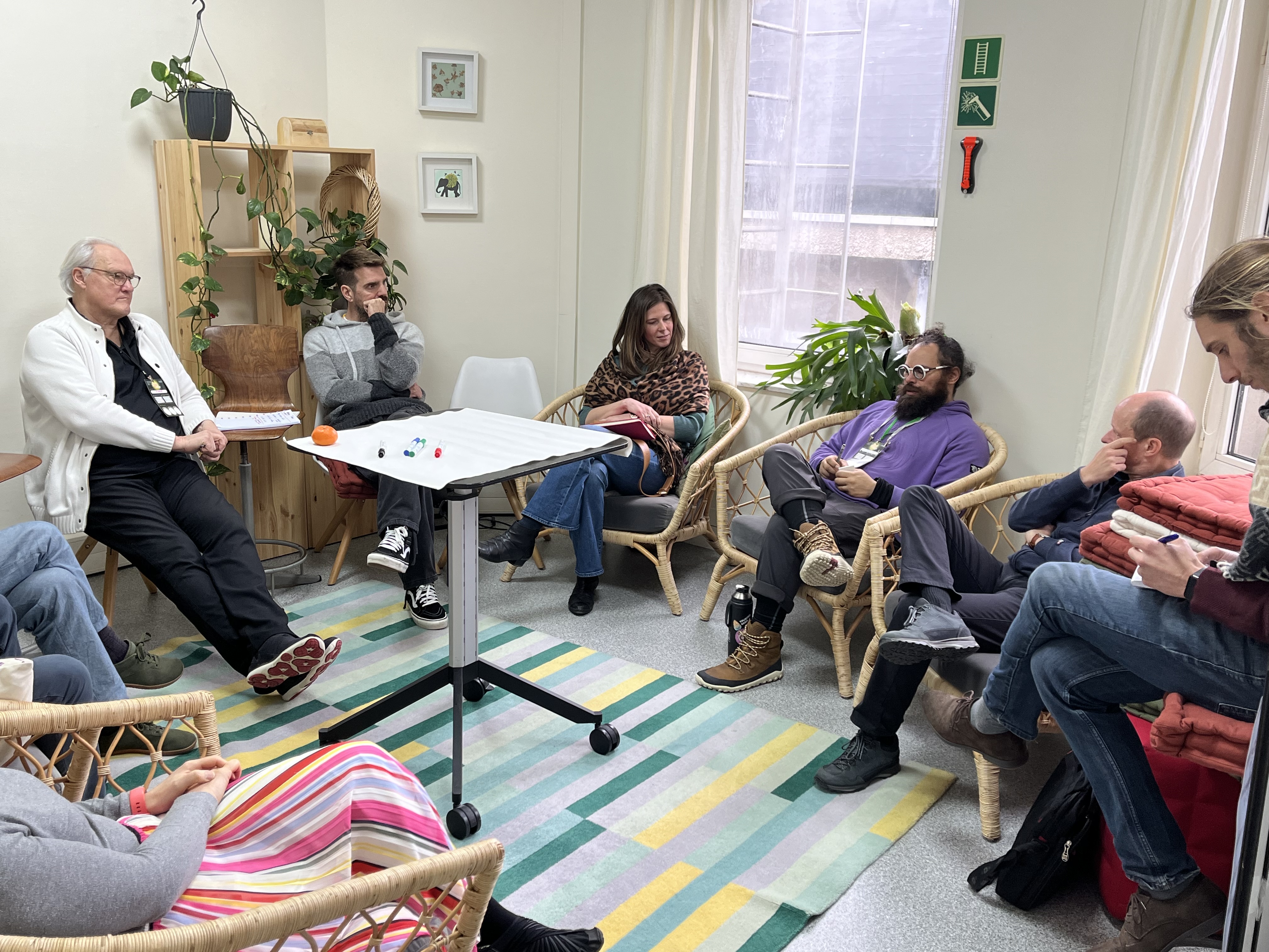 Small group discussion in cozy workshop setting